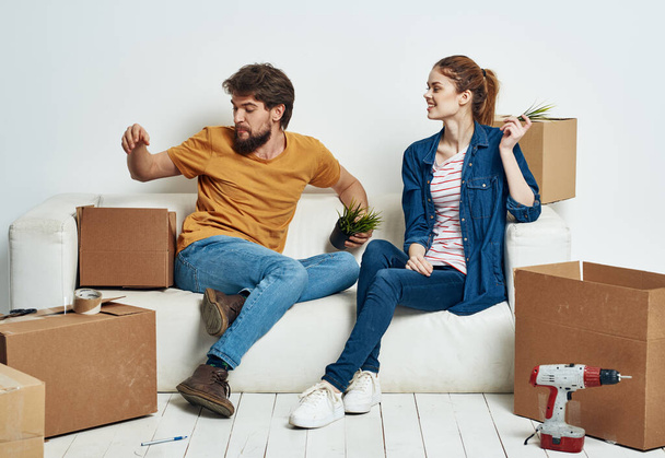 Άντρας και γυναίκα σε ένα νέο διαμέρισμα κουτιά με πράγματα εσωτερικό - Φωτογραφία, εικόνα