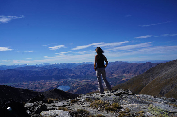 a girl hiker on the peak to enjoy a beautiful view - Zdjęcie, obraz