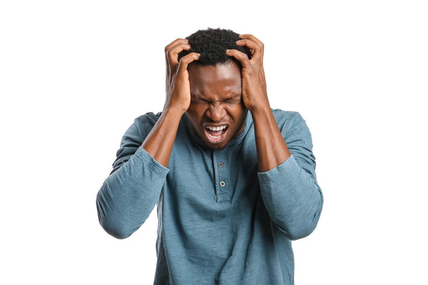 Stressed African-American man on white background - Фото, изображение