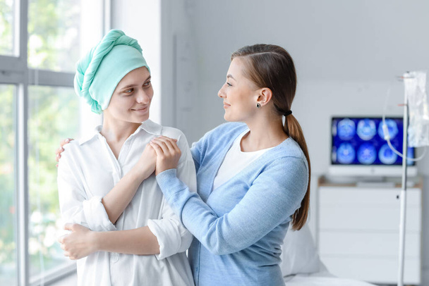 Woman visiting her sister after chemotherapy in clinic - Photo, Image