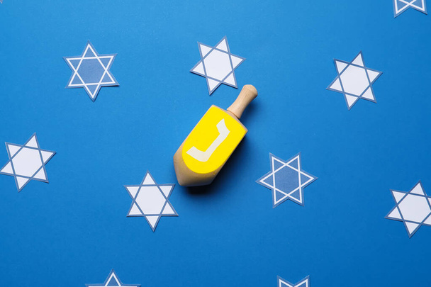 Dreidel for Hanukkah on color background - Photo, Image