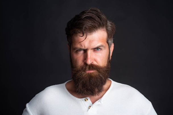 Young handsome man with long beard, mustache and trendy hairdo. - Фото, изображение