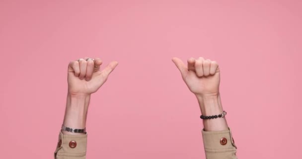 two arms showing palms, pointing at the camera, making an ok sign and celebrating succes against pink background - Záběry, video