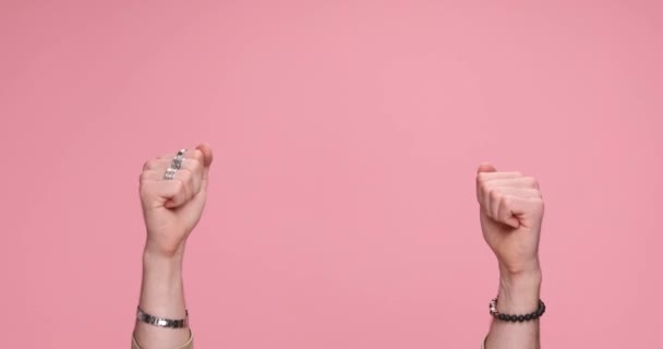 two hands counting up from one to five on each hand on pink background - Footage, Video