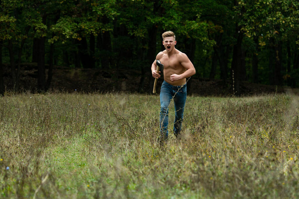 Lumberjack muscled young man run. Shirtless athletic naked guy running, nature outside. - Foto, Imagen