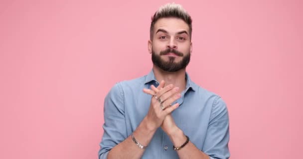 casual excited man rubbing his palms, raising his fists and celebrating succes on pink background - Materiaali, video