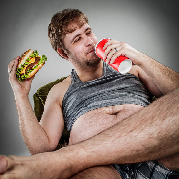Fat man eating hamburger - Valokuva, kuva