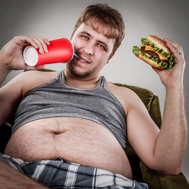Fat man eating hamburger - Fotó, kép
