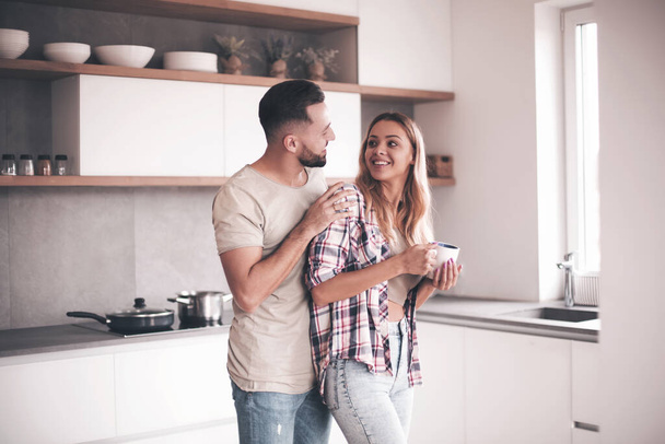 young couple in the kitchen in good morning - Foto, afbeelding