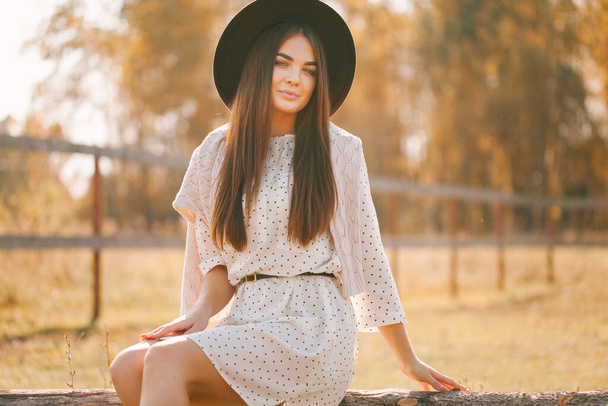 Young beautiful model in a hat on a farm - Фото, зображення