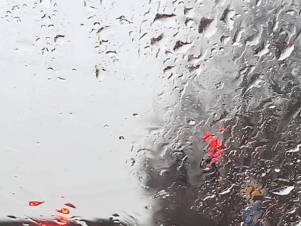 pluie sur la route depuis la fenêtre de la voiture, véhicule dangereux conduisant sous la pluie. Résumé brouillé voiture mauvais temps - Photo, image