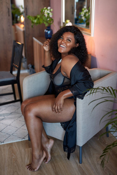 good-looking african woman with half naked plus size body sits on armchair - Foto, Imagem