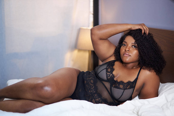 adorable sexy african woman lie on bed at home - Photo, image