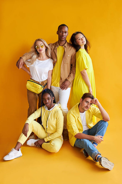 group of multiethnic friends, people of different cultures isolated on yellow background - Valokuva, kuva