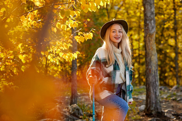 happy caucasian blonde woman is enjoying time in the forest - Valokuva, kuva