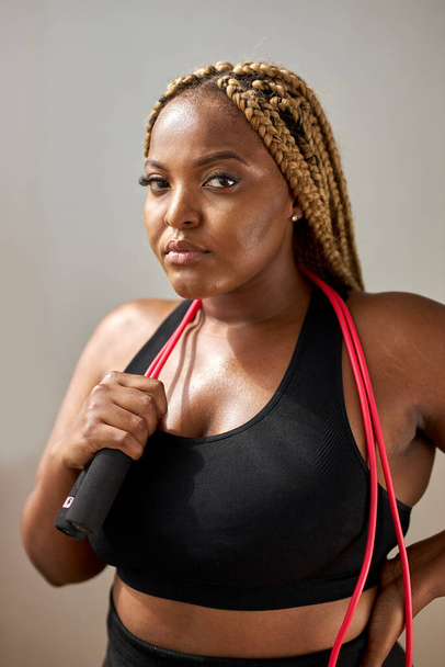 portrait of good-looking african fat woman with skipping rope - Photo, Image