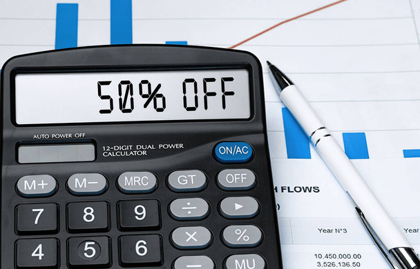 Calculator with the word 50 OFF on the display. Money, finance and business concept - Photo, Image