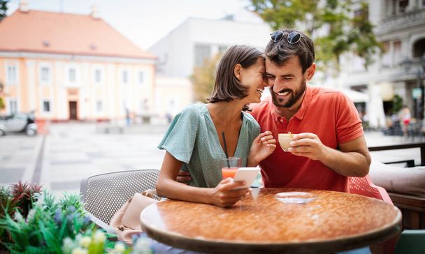 Beautiful couple having fun on a date in a cafe - Фото, зображення
