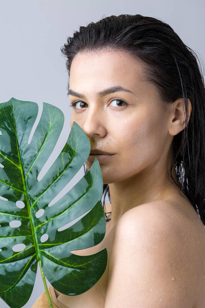 Beauty Woman with natural green palm leaf portrait. Fashion, beauty, make-up, cosmetics. - Zdjęcie, obraz