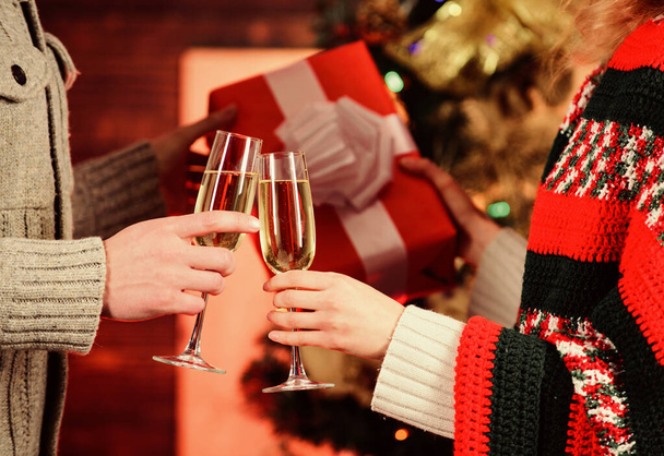 Cheers concept. New year tradition. Merry christmas. Alcohol drink. Glass filled sparkling wine or champagne. Having nice time. Toast. Glass of champagne. Champagne couple glasses. Giving gift - 写真・画像