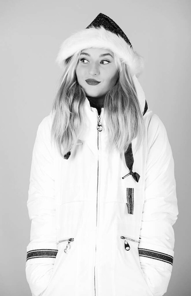Santa girl. Girl wear white jacket and santa hat. Jacket has extra insulation and slightly longer fit to protect your body from sharp winter weather. White jacket. Waiting frosty christmas days - Fotografie, Obrázek