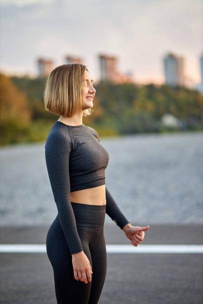 side view on slim happy woman feeling freedom after sport exercises - Valokuva, kuva