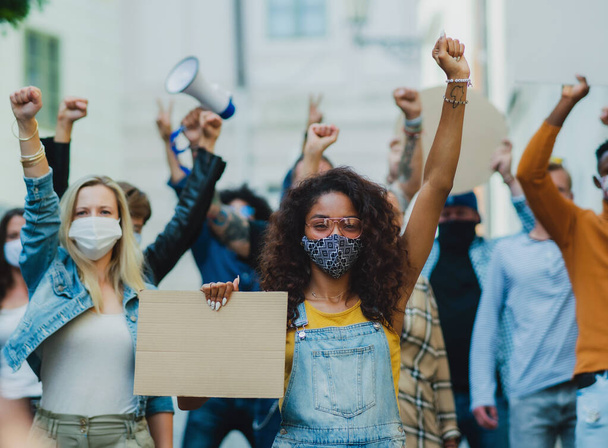 Group of people activists protesting on streets, demonstration and coronavirus concept. - Φωτογραφία, εικόνα