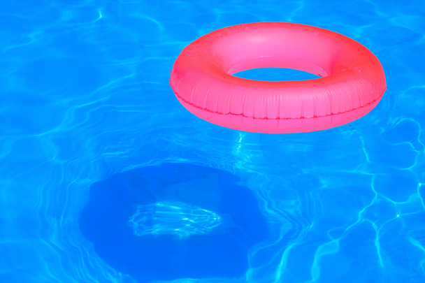 Colorful inflatable ball and round tube floating in swimming pool - Fotografie, Obrázek
