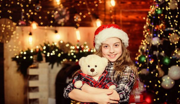 Dreams come true. Kid near christmas tree hold teddy bear soft toy. Childhood memories. Girl satisfied christmas gift. Christmas gift she dreamed about. Best gift ever. Happy new year concept - Фото, изображение