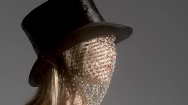 Headshot of woman wearing top hat with sparkly veil dancing - Footage, Video