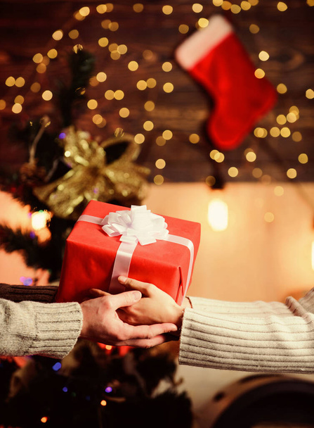 Share with closest. Gift box in hands close up. Handover concept. Christmas wrapped gift with bow. Spread love around. Giving and receiving. Delivery service. Hands holding gift box. Post service - Φωτογραφία, εικόνα