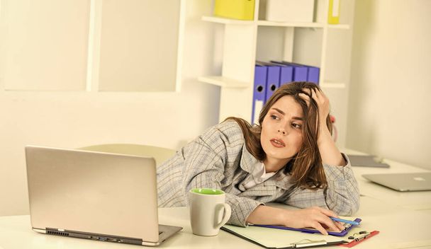 Technology always helps her at work. stylish woman work on notebook. girl follow dress code. tired businesswoman with laptop. elegant woman with document folder. online office worker - Fotó, kép
