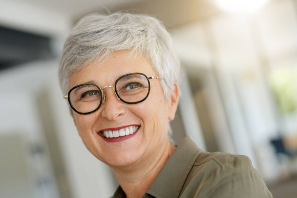 Portrait of a cheerful 55-year-old woman with white hair - Foto, Bild