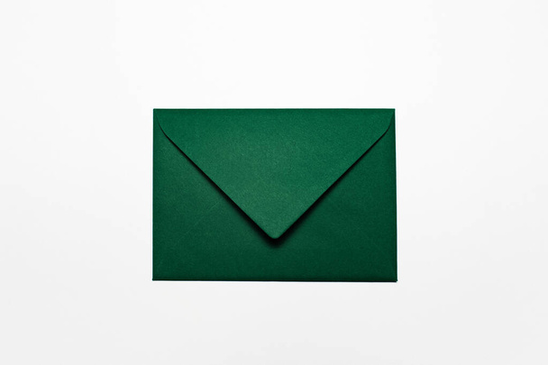 白に分離された緑の紙の封筒の閉鎖. - 写真・画像