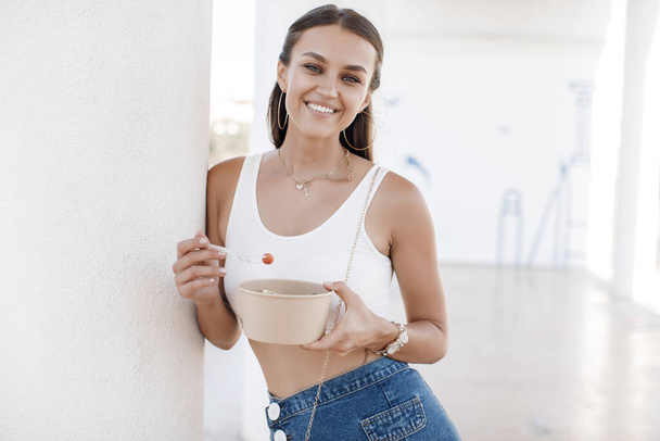 Happy woman with bowl fitness food salmon and vegetables, caucasian woman outdoor - 写真・画像