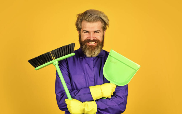 Worker with brush. Cleaning equipment. Yardman occupation. Garbage removal. Cleaning day. Janitor professional. Bearded hipster blue uniform with broom. Gardener cleaning service man. Cleaning agency - Photo, Image
