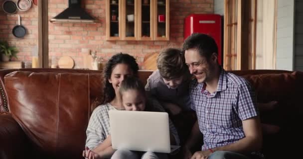 Happy family with kids having fun using laptop - Кадри, відео