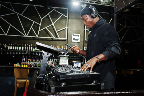 African american dj play music on decks at night club. - Фото, зображення