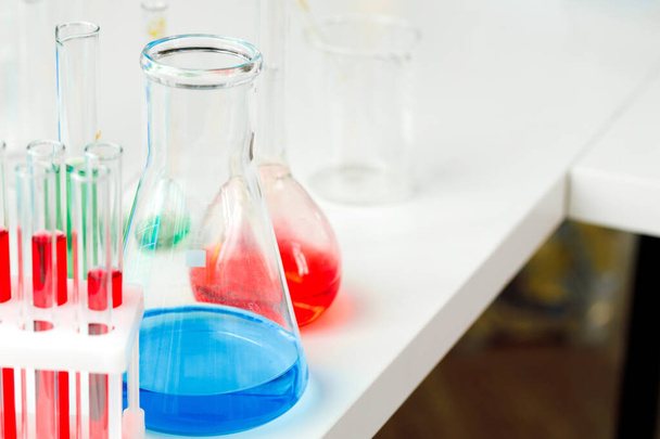 Laboratory glassware with color liquids close up - Foto, Bild