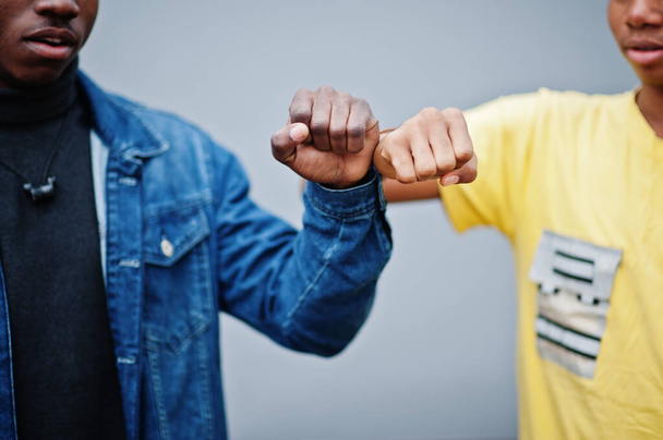 Fist to fist. Two african male friends shaking hands. - Fotoğraf, Görsel