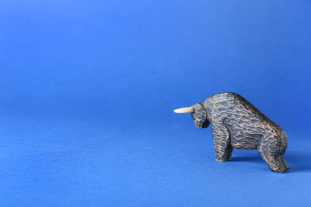 Figurine of bull as symbol of year 2021 on color background - 写真・画像