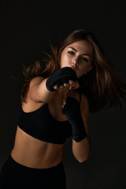 woman with boxing bandages punching - Photo, image