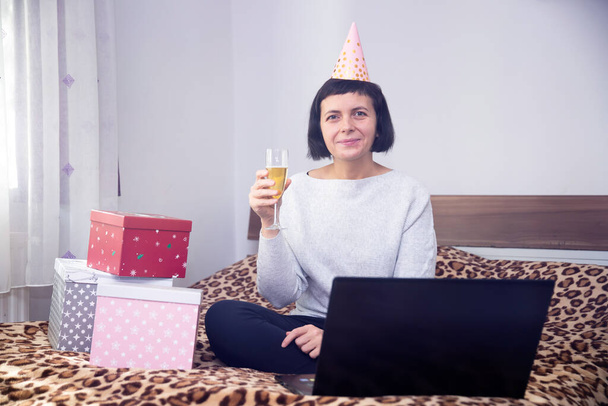 Woman celebrating birthday, Cristmas or New Year online in quarantine time. - Photo, image