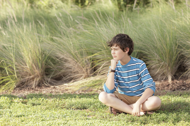 Garçon assis dans un champ
 - Photo, image