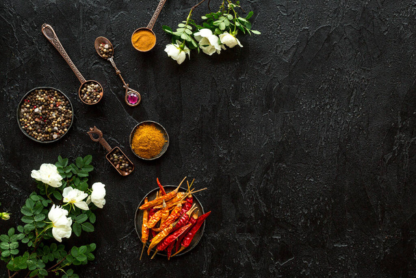 Hot spices set with herbs and flowers, top view - Фото, изображение