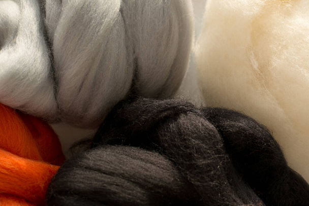 Colorful merino wool, white, black, red and gray colors, for felting, close up - Photo, Image