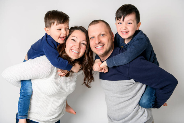 A nice happy family on white background studio - Foto, afbeelding