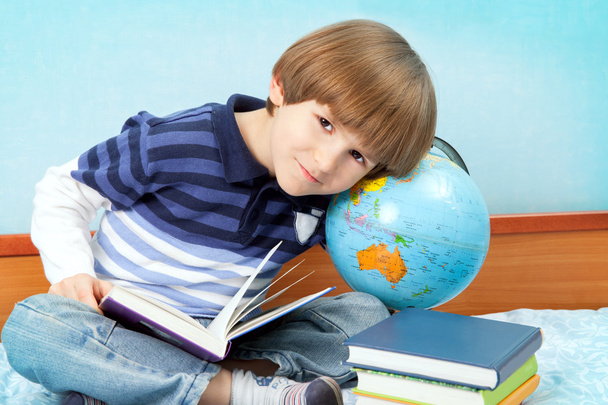 Preschooler with books and globe - Photo, Image