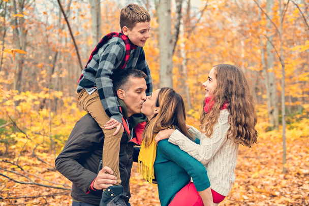 A portrait of a young family in the autumn park - Photo, Image