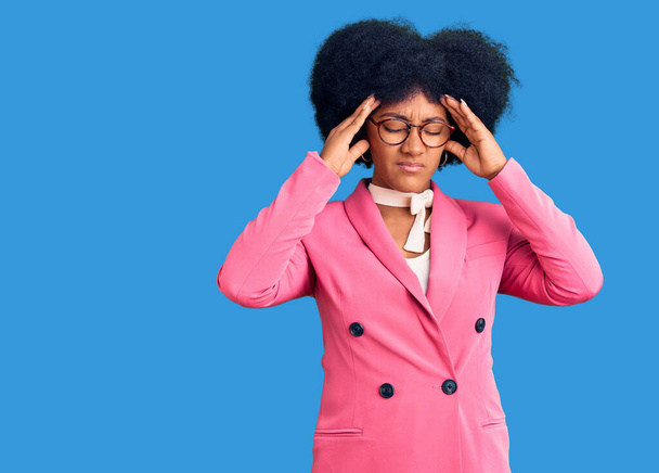 Young african american girl wearing business clothes and glasses suffering from headache desperate and stressed because pain and migraine. hands on head.  - Photo, Image